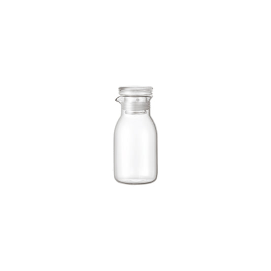 Clear glass bottle with a silver lid on a white background