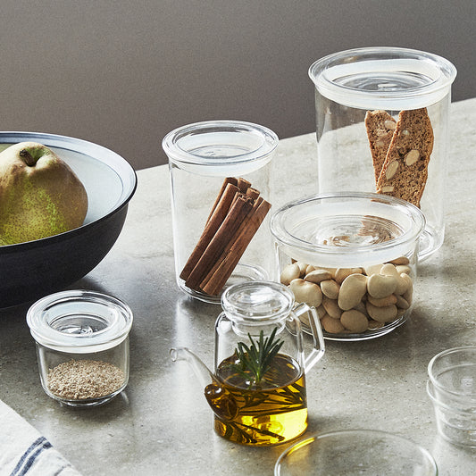 Collection of glass containers with various contents on a table