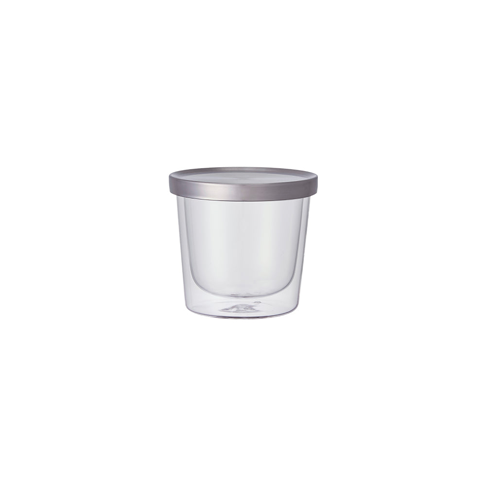 Clear glass container with a silver lid on a white background