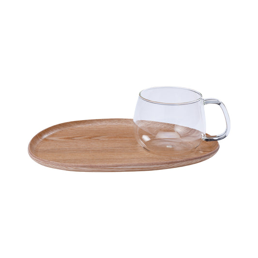Clear glass mug with wooden tray on a white background