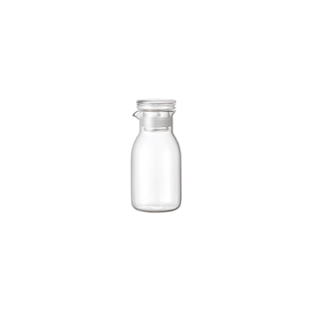 Clear glass bottle with a silver lid on a white background