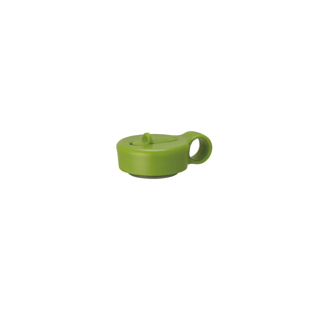 Green plastic bottle cap on a white background