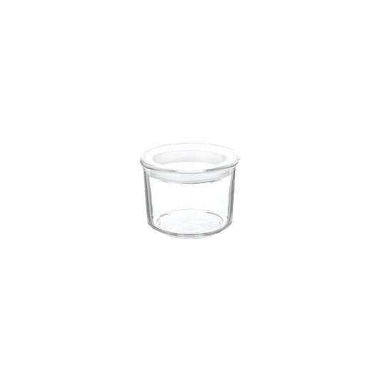 Clear glass container with a white lid on a white background