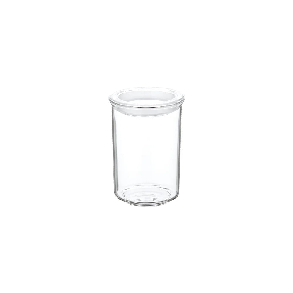 Clear glass jar with a white lid on a white background