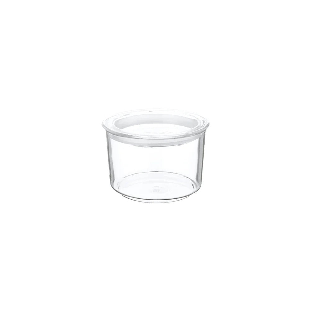 Clear plastic container with a white lid on a white background