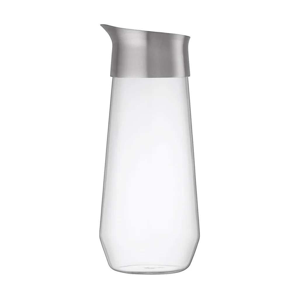 Clear glass carafe with silver lid on a white background